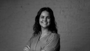 Isabella Medina Headshot at JTWO in black and white in front of brick wall