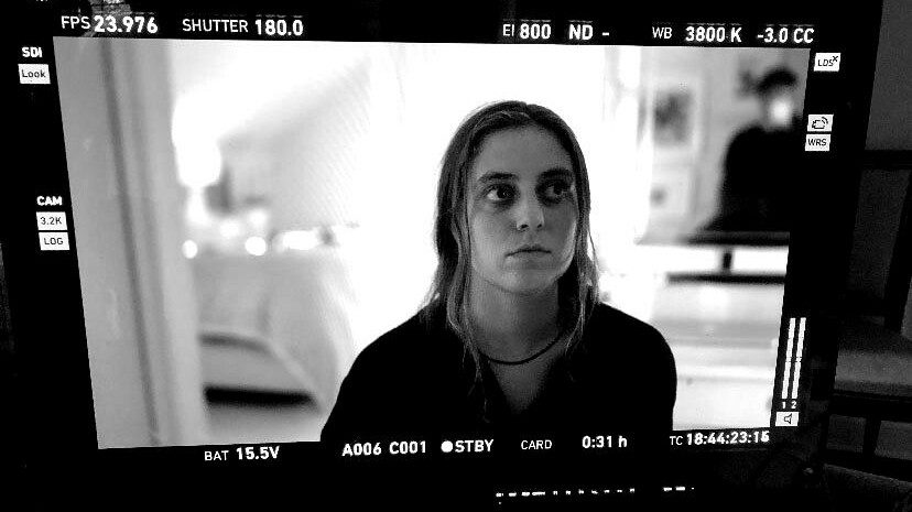 Siena Twiss, an intern at JTWO, seen on a film set through a monitor.